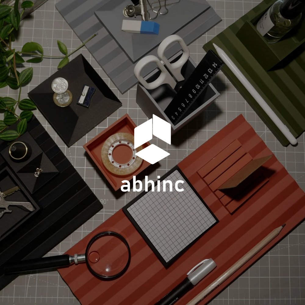 Abhinc RIB modular desk organiser system in Clay, Graphite, Slate, and Sage, styled in an overhead flat-lay with everyday desk objects
