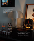 Illuminated clock sitting on an eclectic sideboard