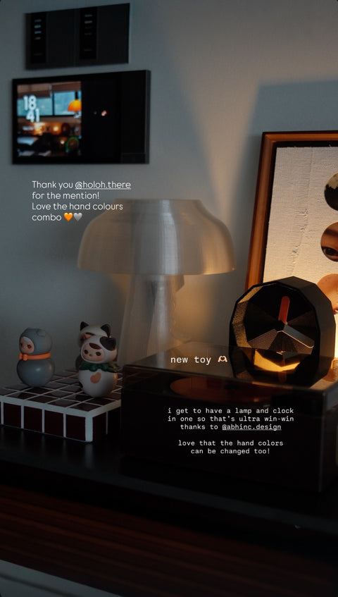 Illuminated clock sitting on an eclectic sideboard