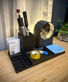 Desk organizer with stationery items on a wooden surface