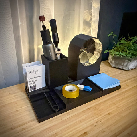 Desk organizer with stationery items on a wooden surface