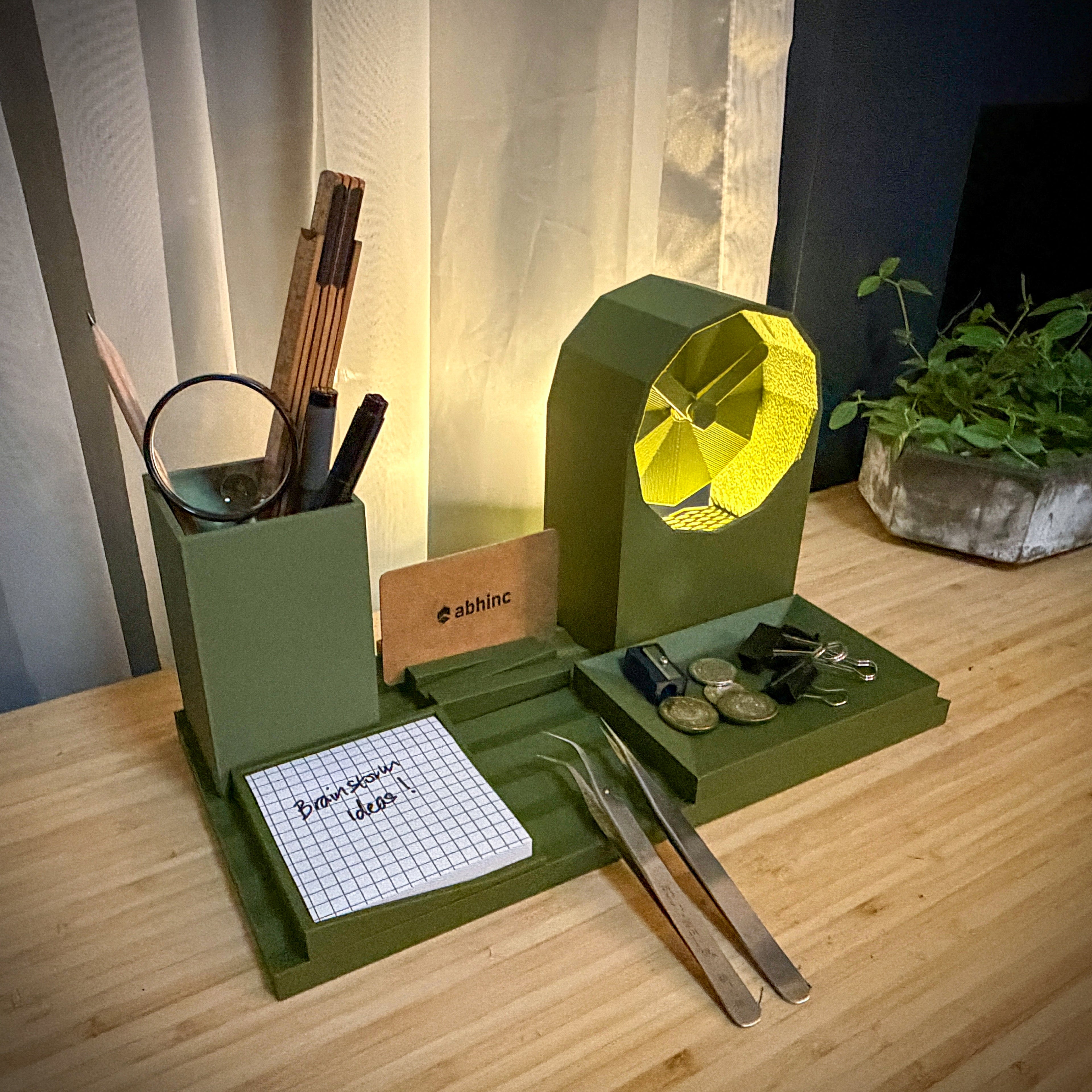 Green desk organizer with various items on a wooden surface