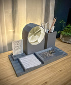 Gray desk organizer with geometric design on a wooden surface